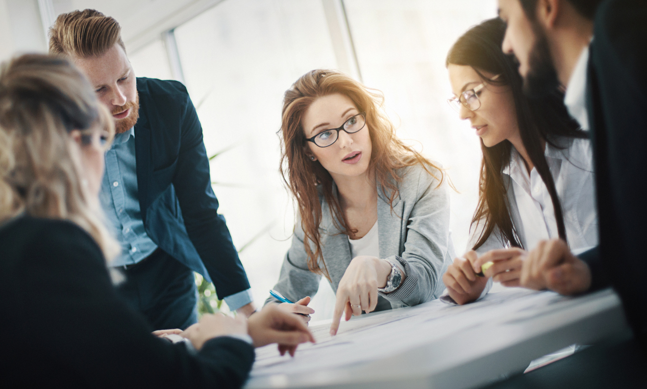 Group of male and female employees in serious meeting