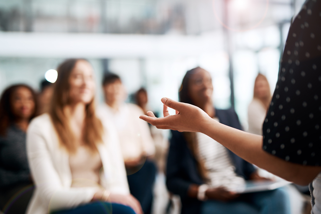 Blurred background but focused zoomed in photo of a meeting presenters hand