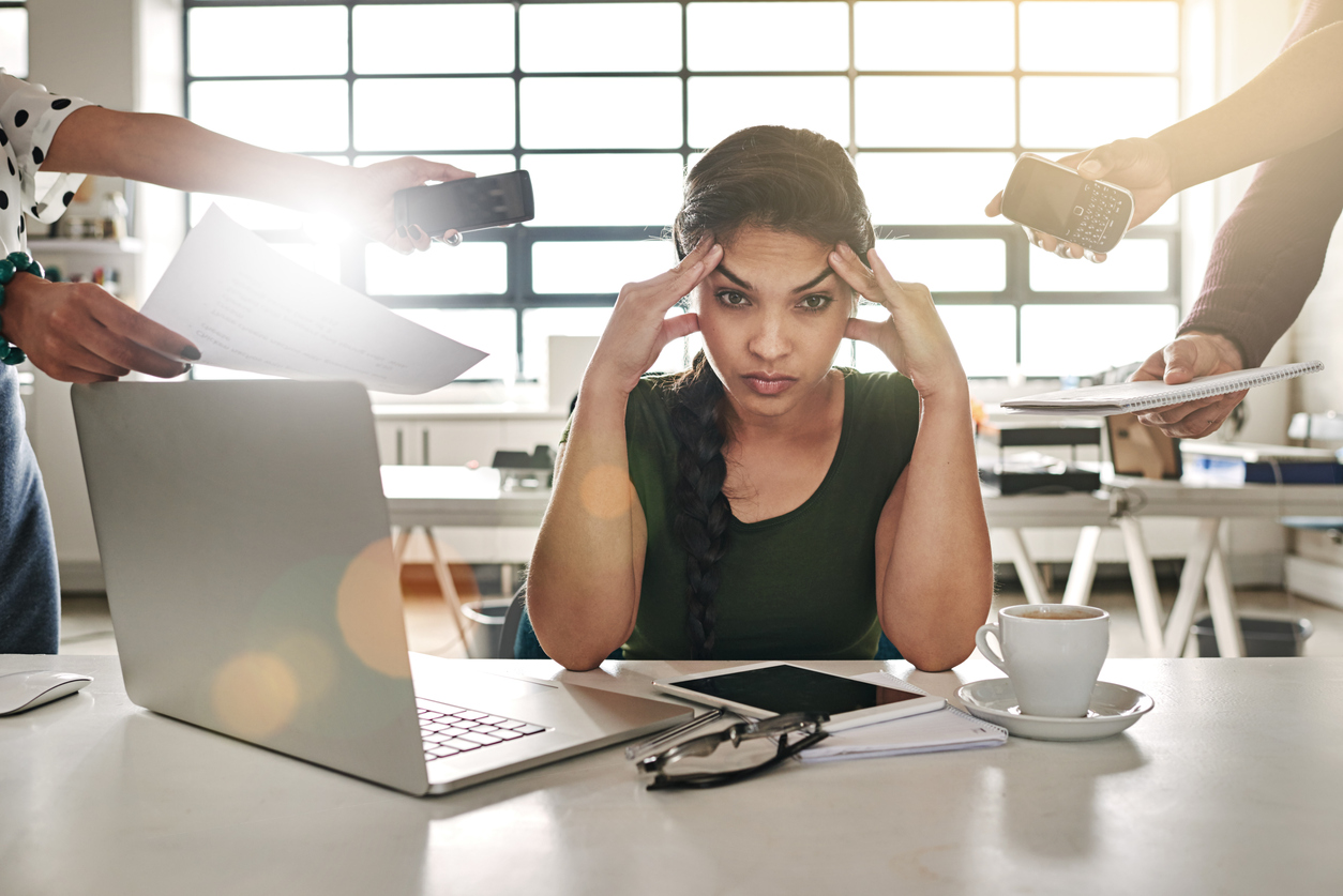 Stressed out employee on her laptop