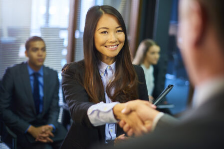 Female employee shaking hands with male