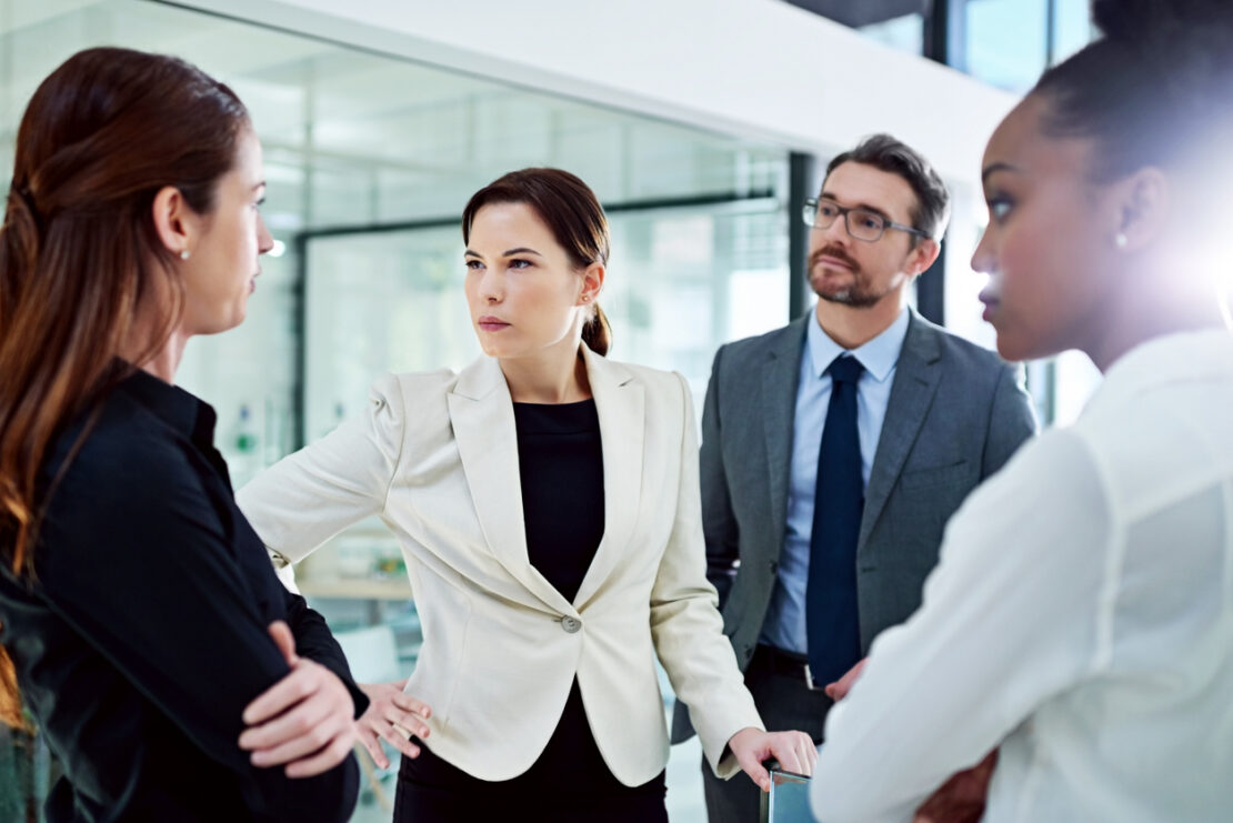 Group of employees in the middle of a work conflict